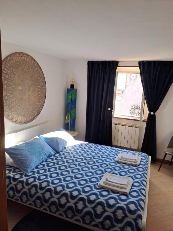 a bedroom with a bed with two towels on it at Serenissima Apartment in Muggia
