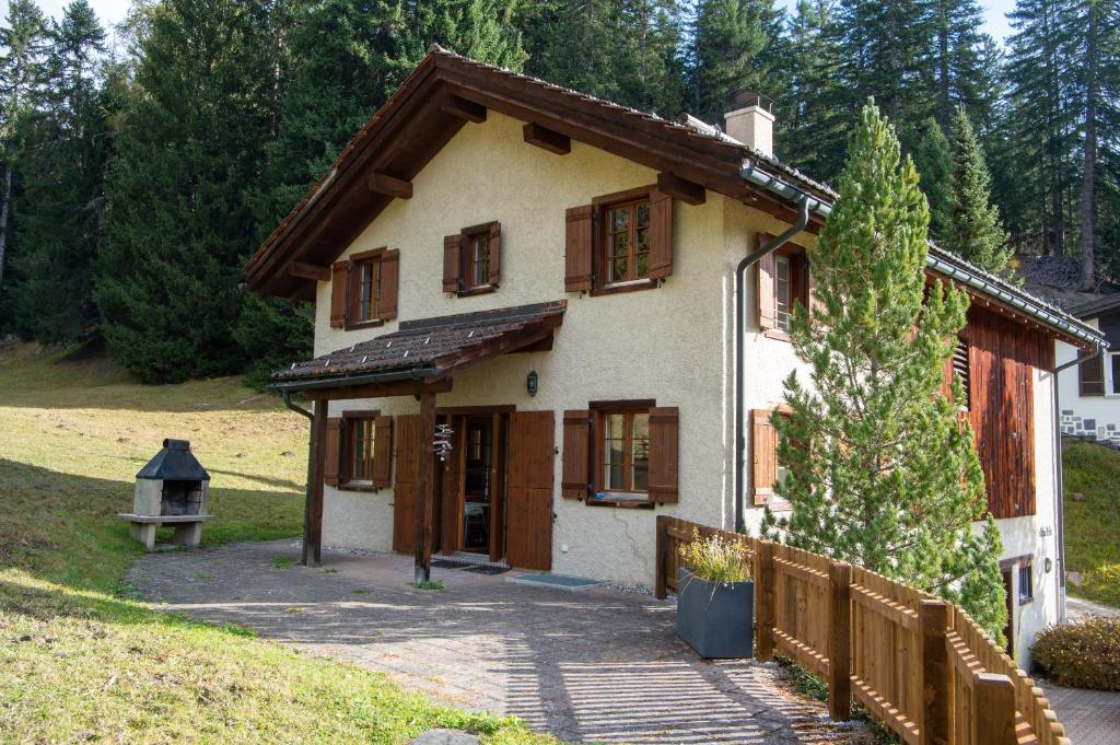 a small house with a fence in front of it at Charming ski-in ski-out mountain hut in Lenzerheide