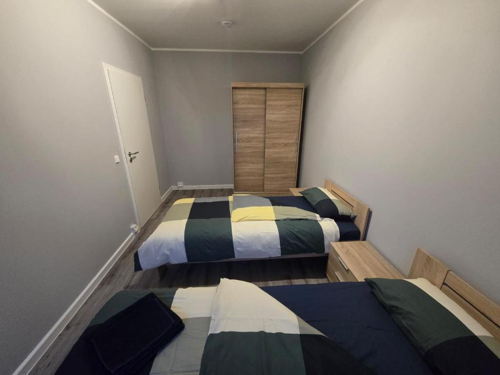 a bedroom with two beds and a closet at Komfortable 2-Zimmer-Monteurwohnung für 4 Personen in Leipzig in Leipzig