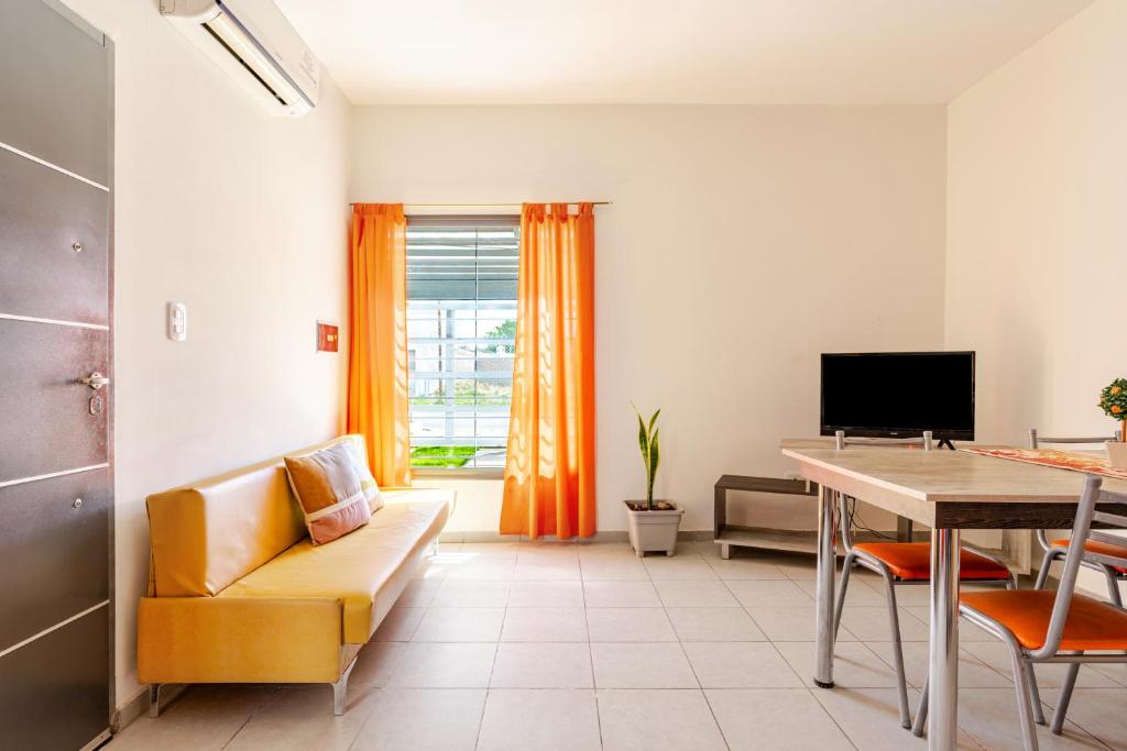 a living room with a couch and a table at Departamentos Brown in San Rafael