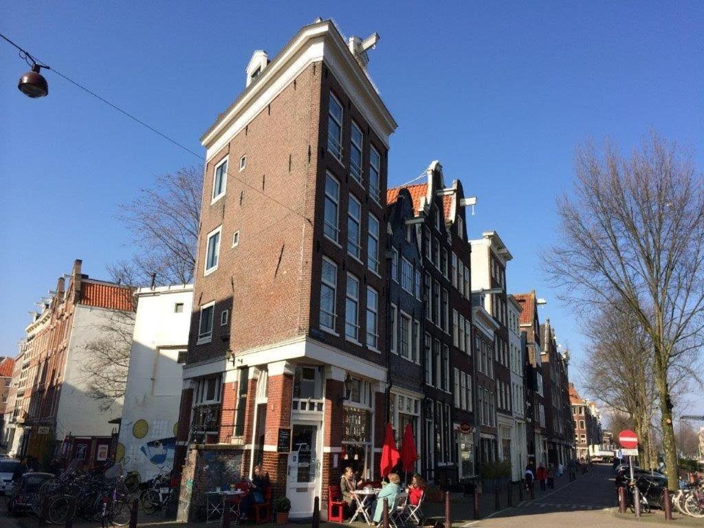 un grand bâtiment en briques sur une rue de la ville dans l'établissement Bridge Inn, à Amsterdam