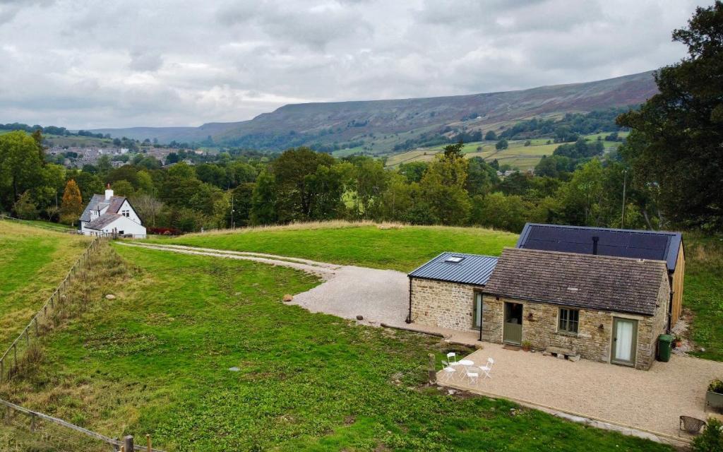 an aerial view of a small house on a hill at Neddy Meadow in Grinton