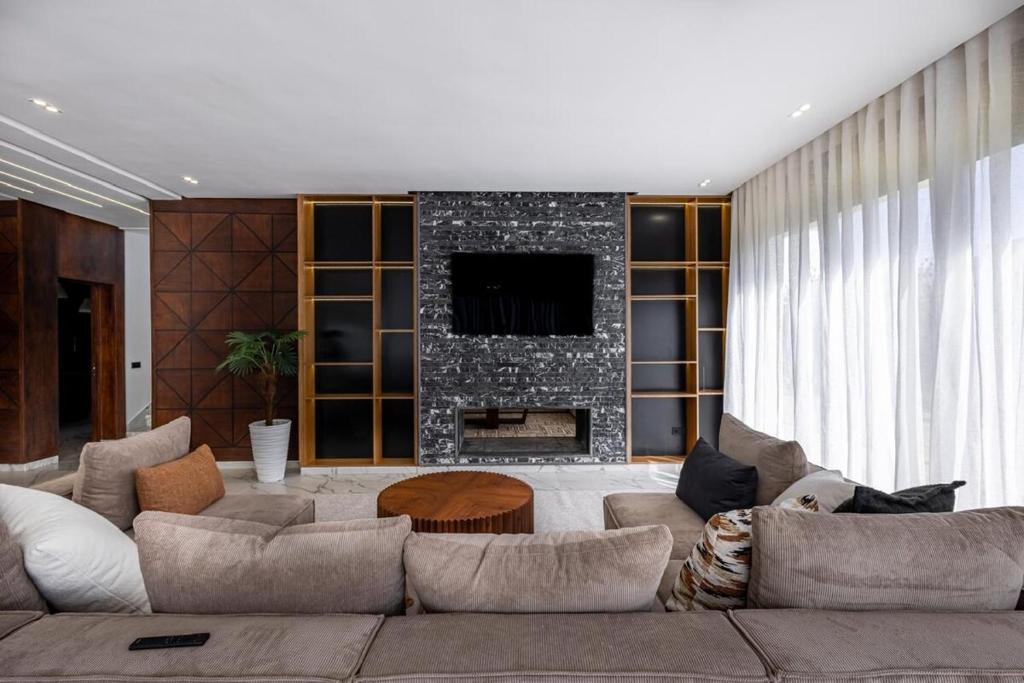 a living room with a couch and a fireplace at Villa Indigo in Rabat
