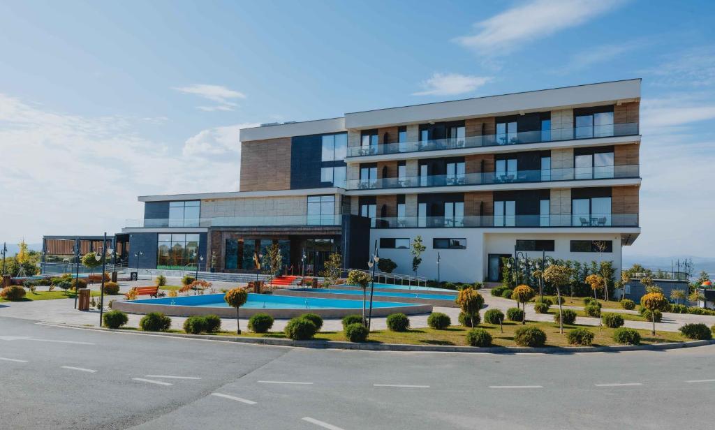 a building with a pool in front of it at Iliria Hill Resort & Spa in Orllan