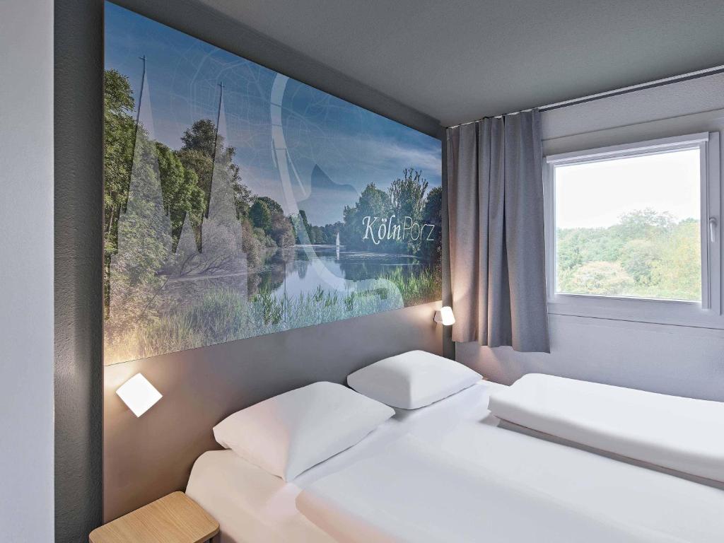 Ένα ή περισσότερα κρεβάτια σε δωμάτιο στο B&B HOTEL Köln-Porz