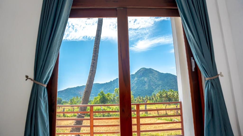 a window with a view of a mountain view at Diamond Mount Villa in Dambulla
