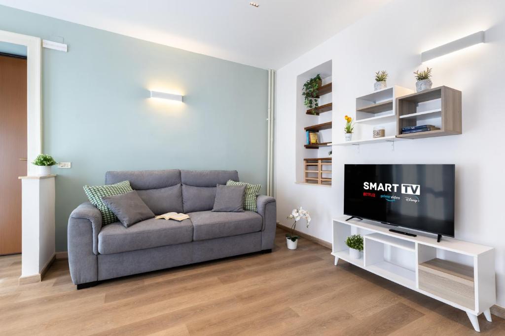 a living room with a couch and a tv at NEW Luxury Flat 10min P Nuova in Turin