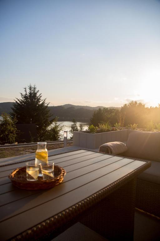 a table with a bowl of food on top of a deck at Nad Jeziorem in Rożnów
