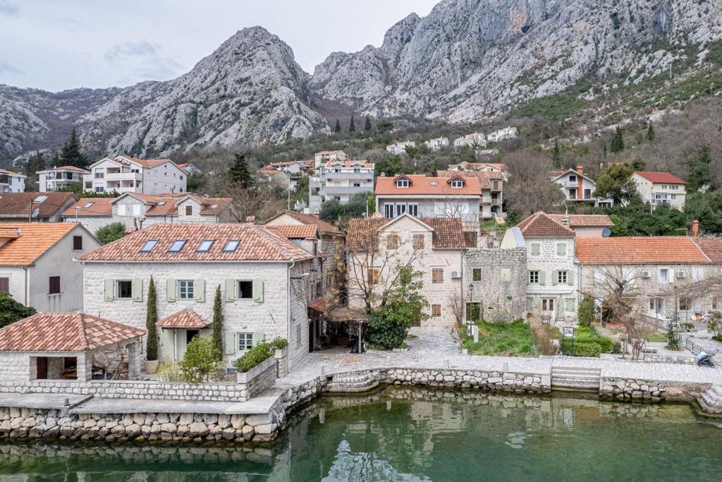 a town with a lake and mountains in the background at Sponza House in Trstenik