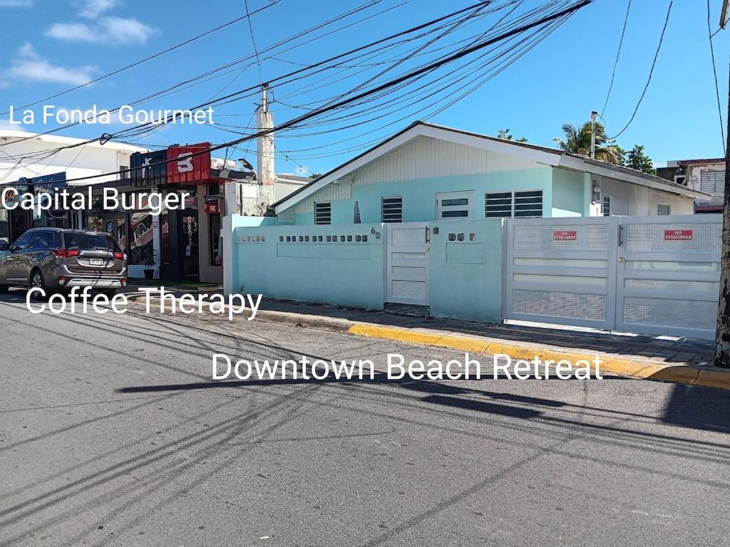a street with a fence and a building on a street at Downtown Beach Retreat in Luquillo