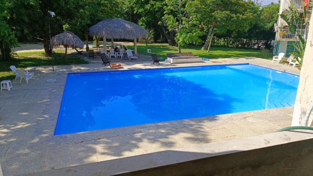a large blue swimming pool in a yard at Newly remodeled apartment in Huatulco in Santa Cruz Huatulco