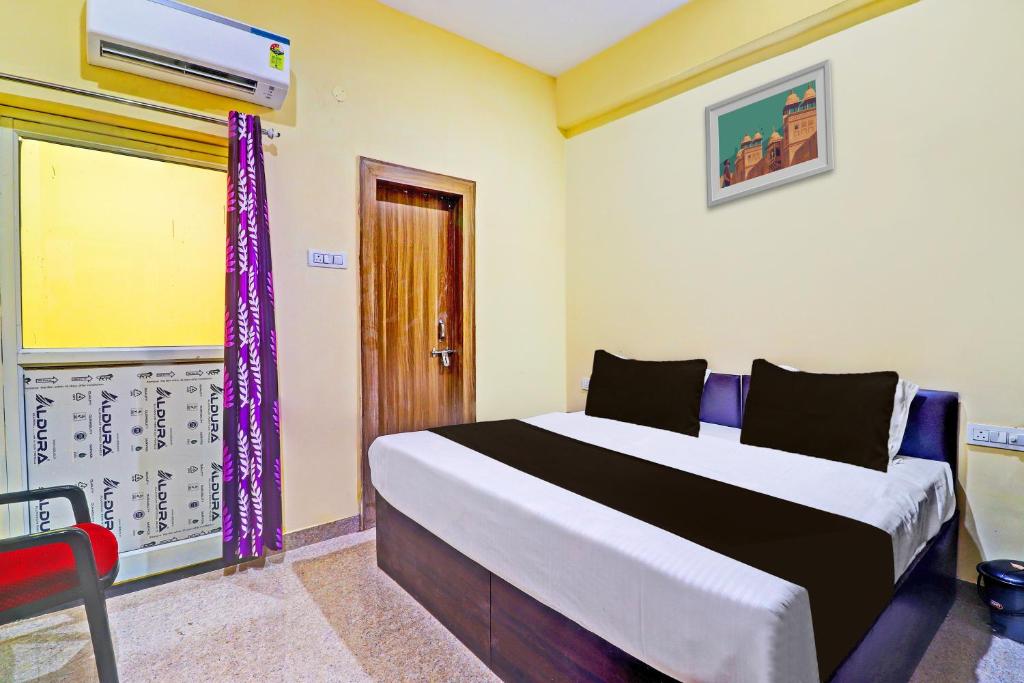 a bedroom with a large bed with purple curtains at Hotel O Heaven Inn in Gwalior