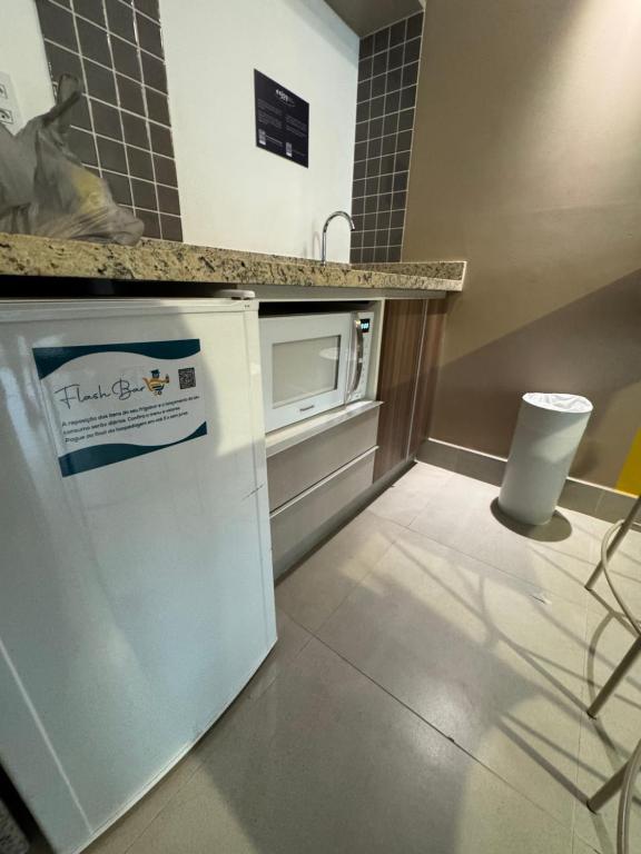 a kitchen with a sink and a microwave at Enjoy Olímpia Park Resort in Olímpia
