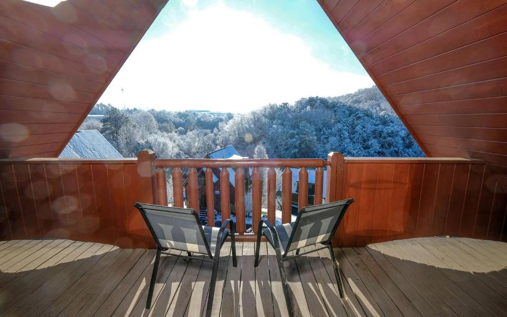 two chairs on a balcony with a view of a mountain at Above it All・3 Mi to Dollywood・Hot Tub・Pool Table・Pet Friendly in Pigeon Forge