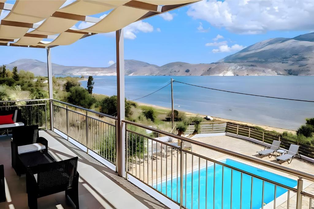 a balcony with a view of the water and mountains at Euphoria Apartments in Kouvaláta
