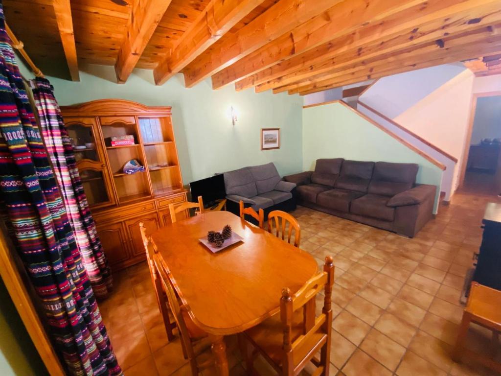 a living room with a table and a couch at Casa Forn in Ortells