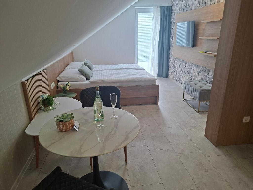 a small room with two tables and a bed at BRIGITA Holiday Rooms - udobje, mir in sprostitev v bližini jezera in Gorica pri Slivnici