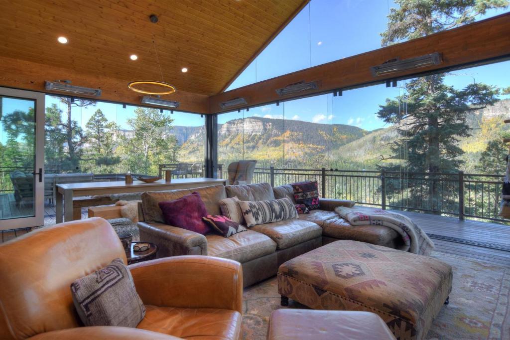 a living room with a couch and a large window at 2001 Lake Purgatory Drive in Durango