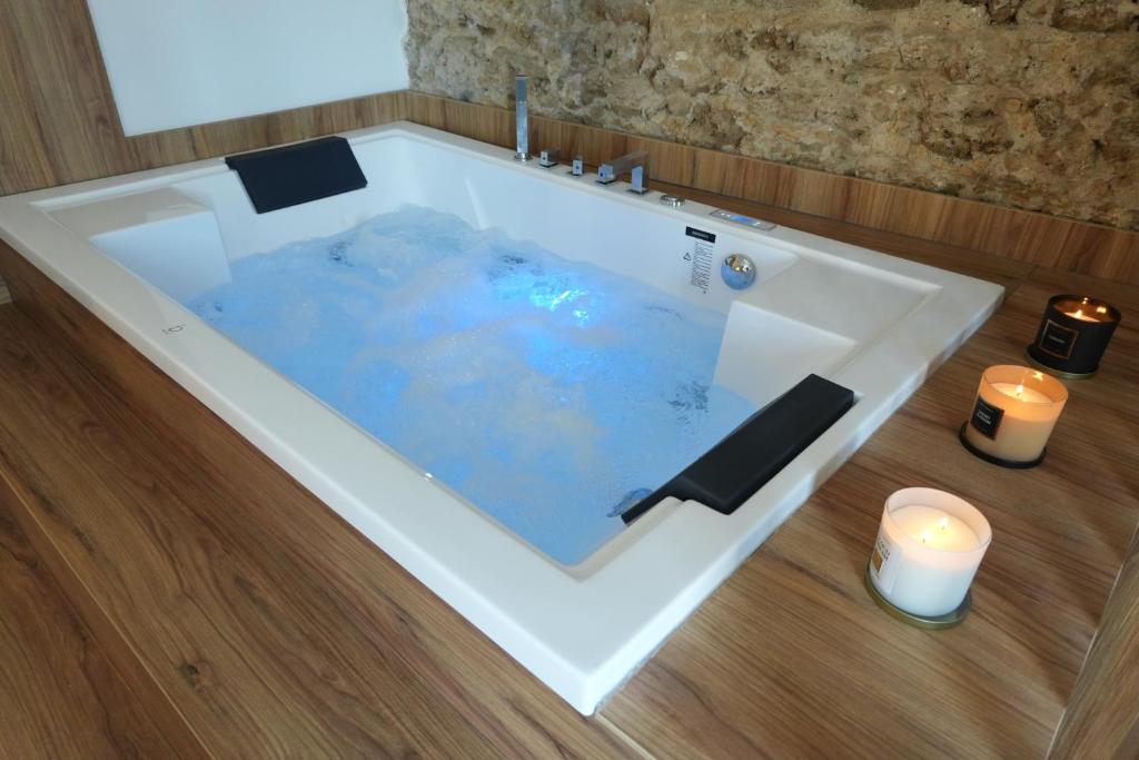 a white bath tub with two candles and two candles at Conte Luxury Rooms in Salerno
