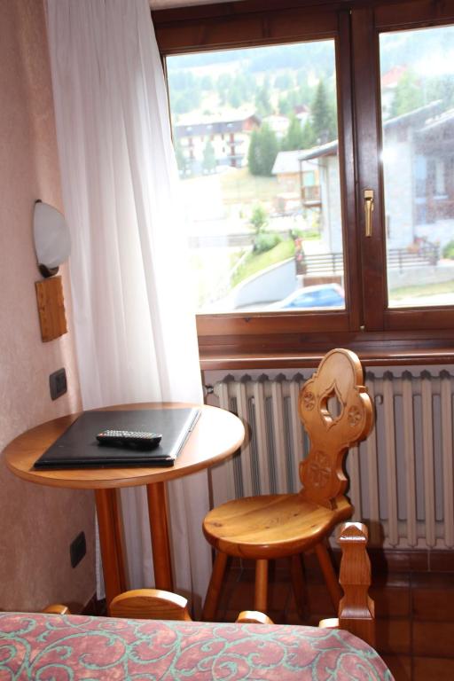 a room with a table with a laptop on it at Hotel Banchetta in Sestriere