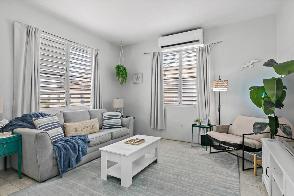 a living room with a couch and a table at Town Treasure - Walkable - King Bed - AC in Christiansted