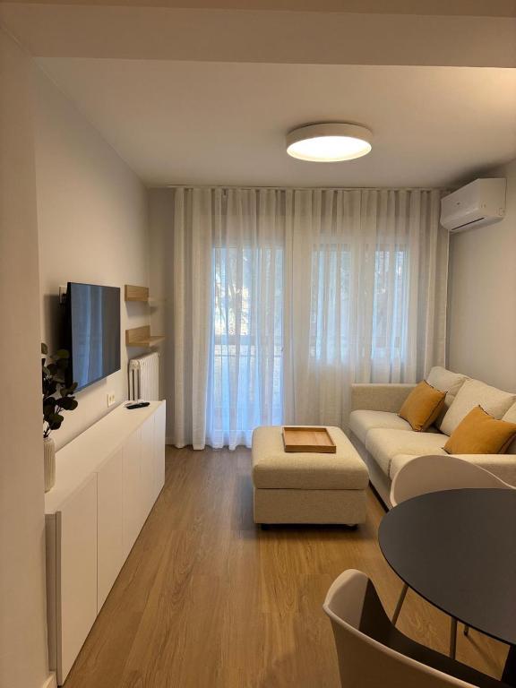 un soggiorno con un divano e una TV di Apartamento Bailatús a Saragozza