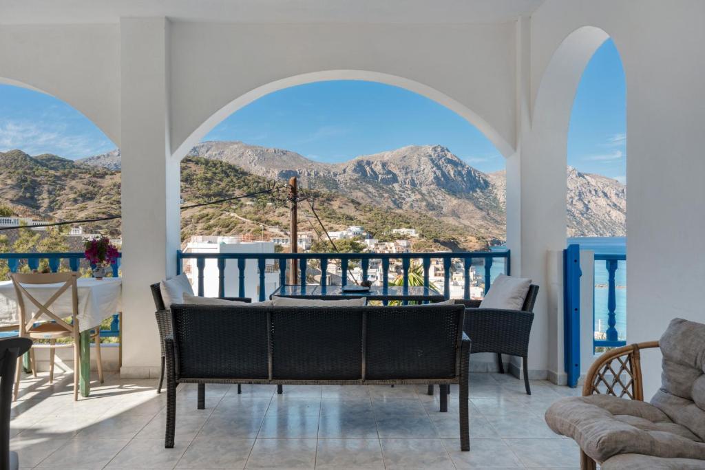 a dining room with a view of the mountains at Hotel Glaros Karpathos in Diafani