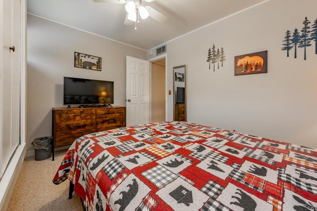 a bedroom with a bed and a flat screen tv at 508G Two Bedroom One Bath in Thayerville