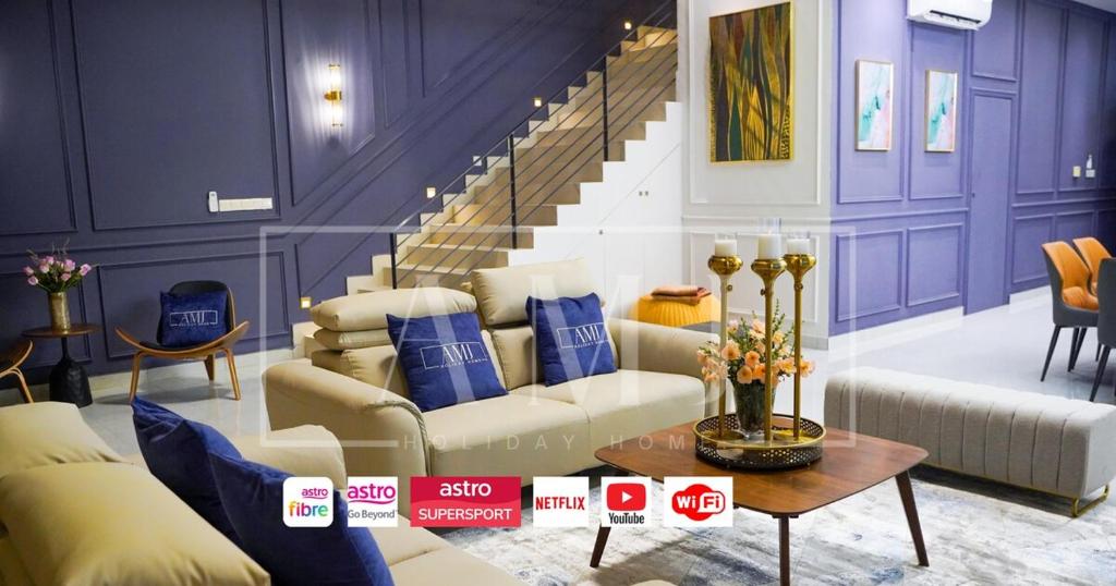 a living room with a couch and a staircase at Cyberjaya Luxury Pool Villa Corner lot 16-20 pax in Puchong