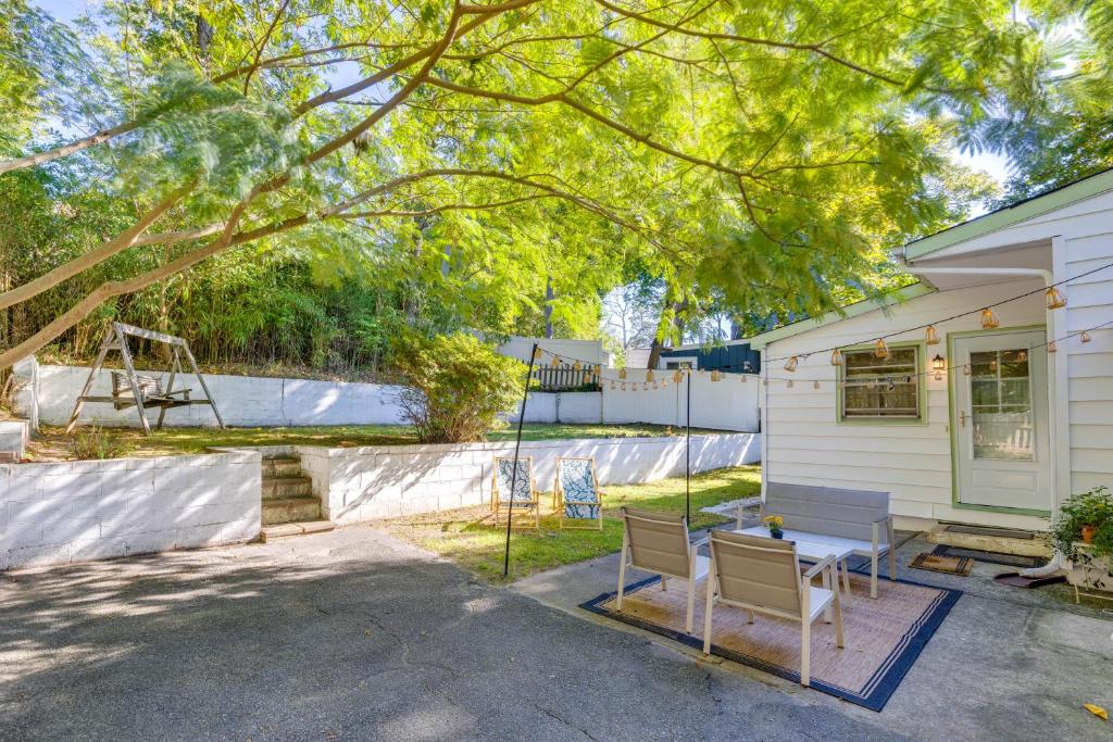 a house with a table and chairs in a yard at No Pet Fee! Home with Private Yard in Rocky Point in Rocky Point