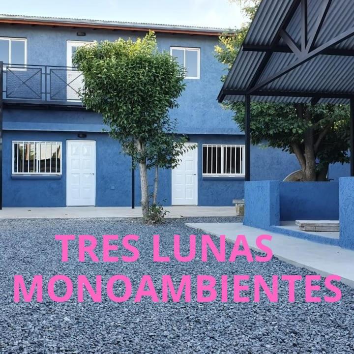 a blue house with a sign that reads trees at Tres Lunas in La Falda