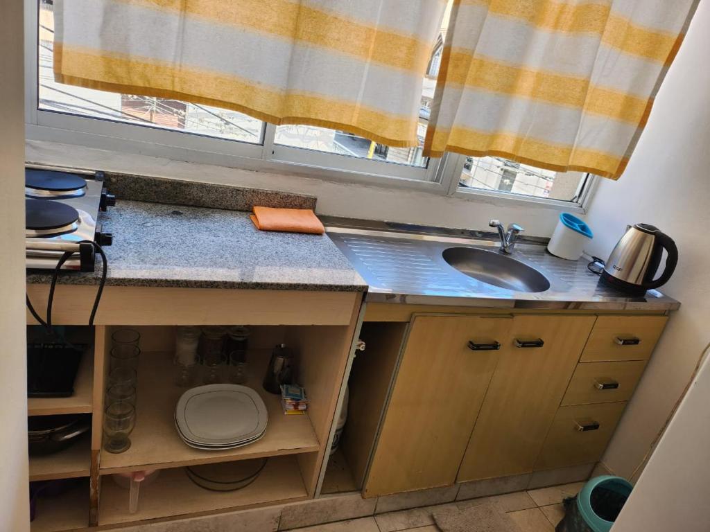 a kitchen counter with a sink and a window at Alma Jujeña in San Salvador de Jujuy