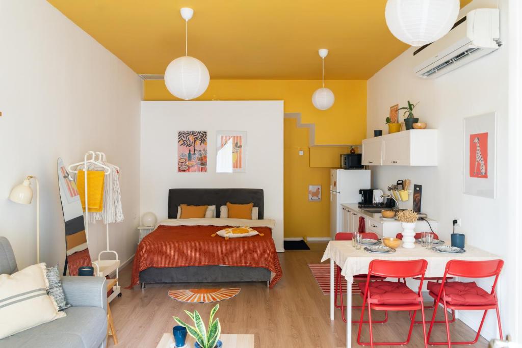 a bedroom with a bed and a table and chairs at Dotan's Boutique Studios - By The Beach! in Tel Aviv