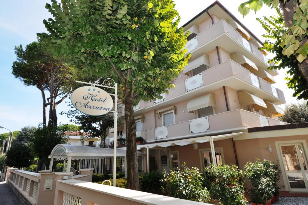 a building with a sign in front of it at Hotel Azzurra in Marina di Pietrasanta