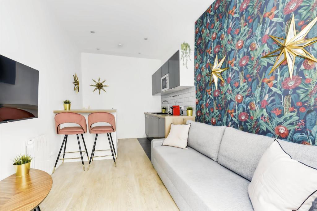 a living room with a couch and a table at Convinient souplex basement 5mn near métro and Montmartre in Paris
