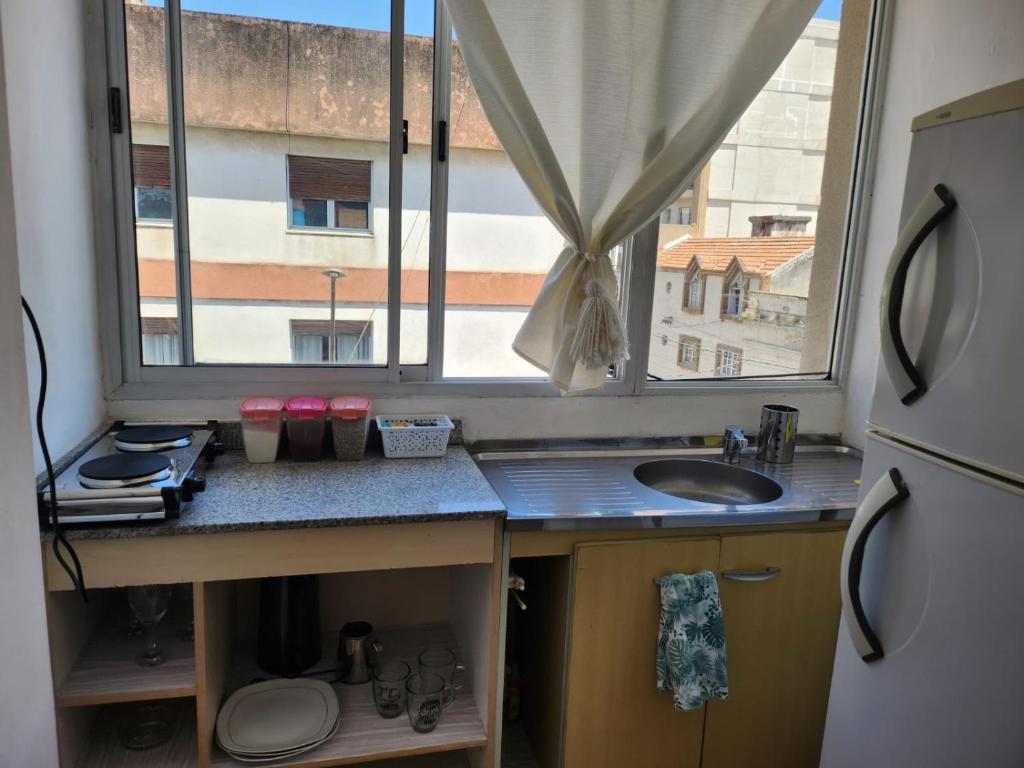 a small kitchen with a sink and a window at Abrazo del Norte in San Salvador de Jujuy