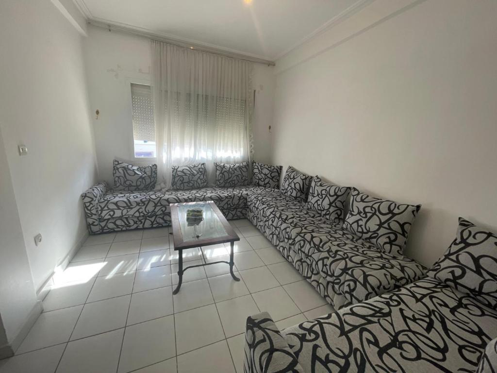 a living room with a couch and a table at luxury apartment in fez in Oulad Akkou