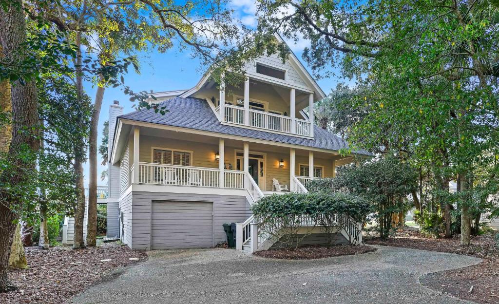 a white house with a porch and a balcony at SM08: 8 Silver Moss in Kiawah Island