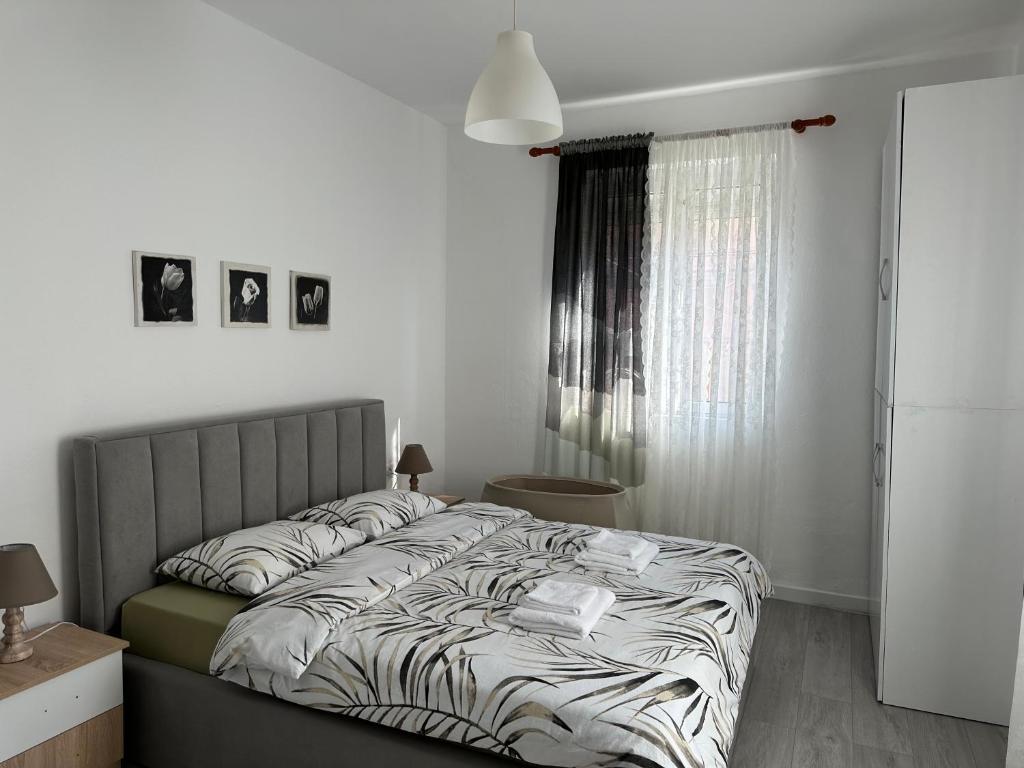 a bedroom with a bed with a zebra print sheets at Apartment Center Korça in Korçë