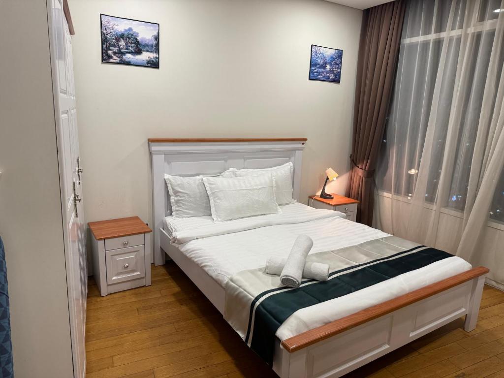 a bedroom with a bed with white sheets and pillows at Vortex Suites klcc City Road By Classic Crest in Kuala Lumpur