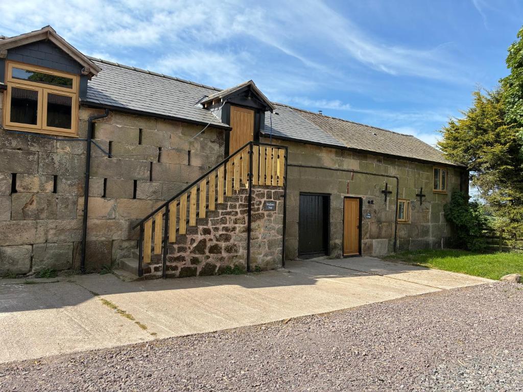 an old stone building with a staircase in front of it at The Cottage at Clive in Clive