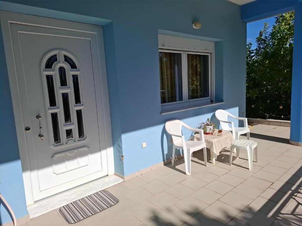 a patio with a table and chairs next to a door at Dinaki apartment in Florina