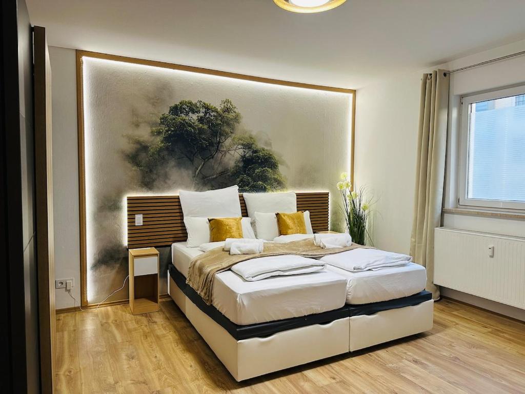 a bedroom with a bed with a painting on the wall at YAYstay - Forest I 65m2 I Balcony I TV I Bahnhof in Mühldorf