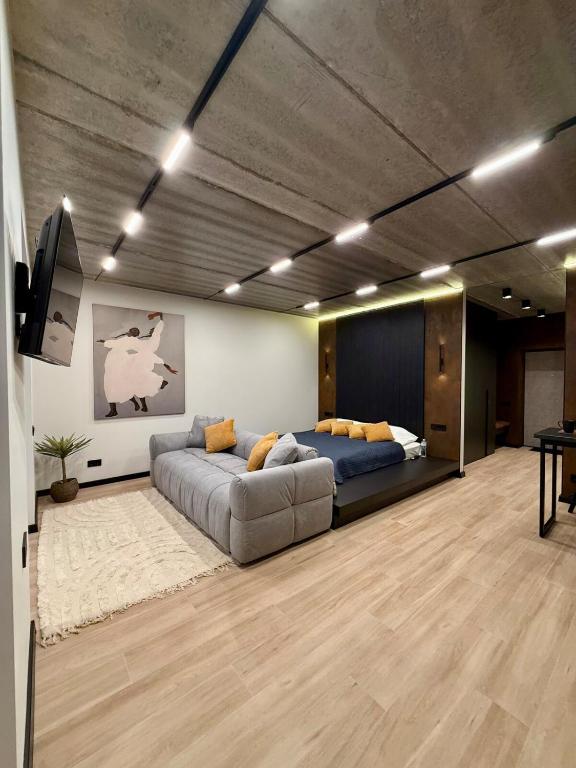 a large living room with a couch and a tv at New Premium LOFT studio in Zhytomyr