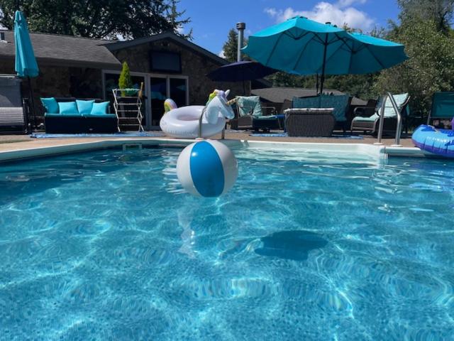a swimming pool with a ball in the water at Large Recreational Retreat in Hudson
