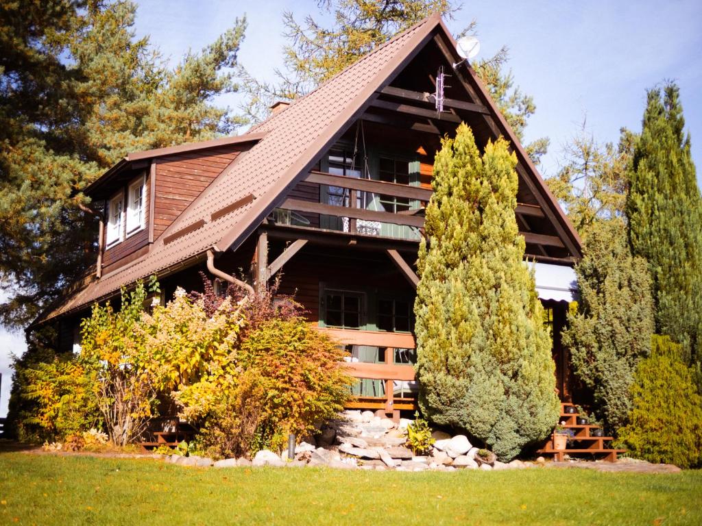 a large house with a gambrel roof at Dom Zielarki na Kaszubach - widok na jezioro, sauna, balia in Żuromino