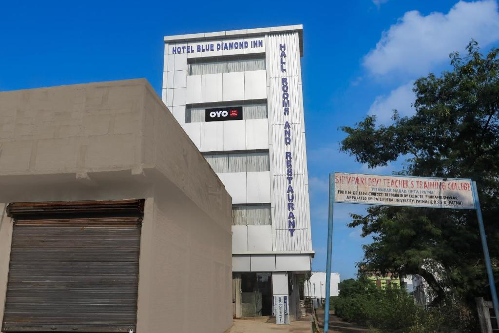 a building with a sign on the side of it at SPOT ON Hotel Blue Diamond Inn in Bihta