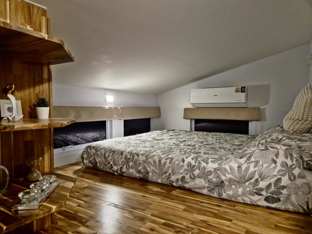 a bedroom with a bed and a wooden floor at Samui Tiny House villa Glamping, Seaview sleeps 8 in Koh Samui