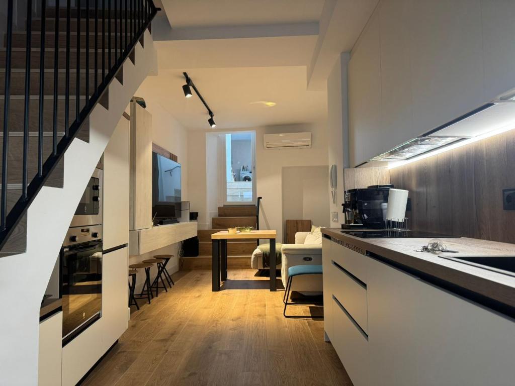a kitchen with white cabinets and a counter top at Casa Papá Rosendo in Bedmar