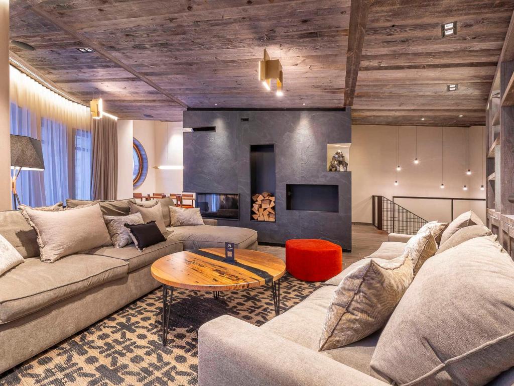 a living room with a couch and a table at Superbe appartement 6 pièces, luxe et confort, piscine et SPA, 10 pers., Morzine - FR-1-314-99 in Avoriaz